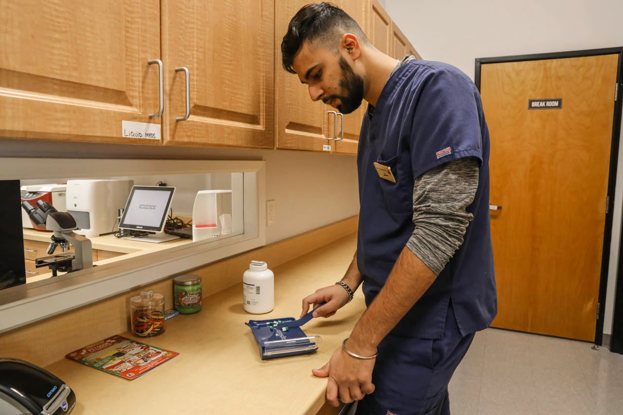 Veterinary technician reviewing notes on a tablet at Stonelake Animal Hospital